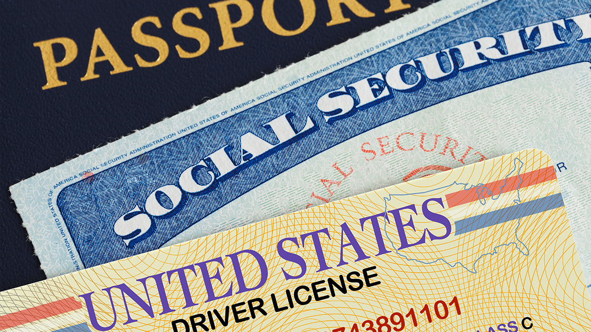 United States Driver License on top of an American Social Security Card on top of a US passport