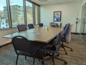 Medium conference room photo of a board table and chairs.