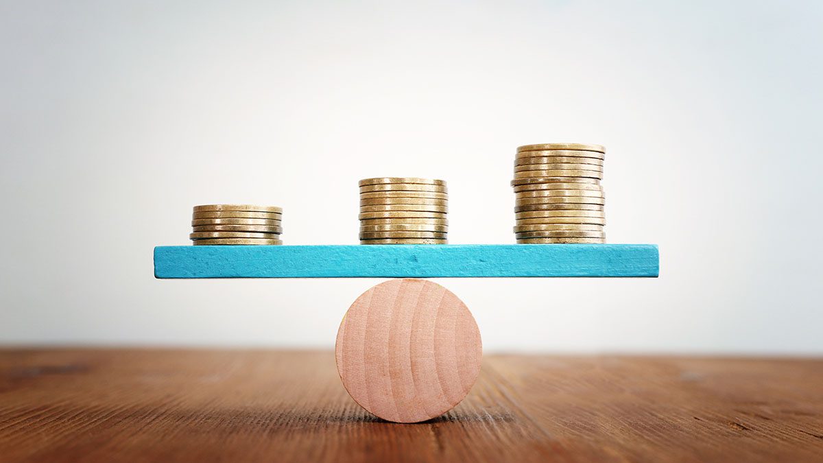 Stack of coins balance on seesaw