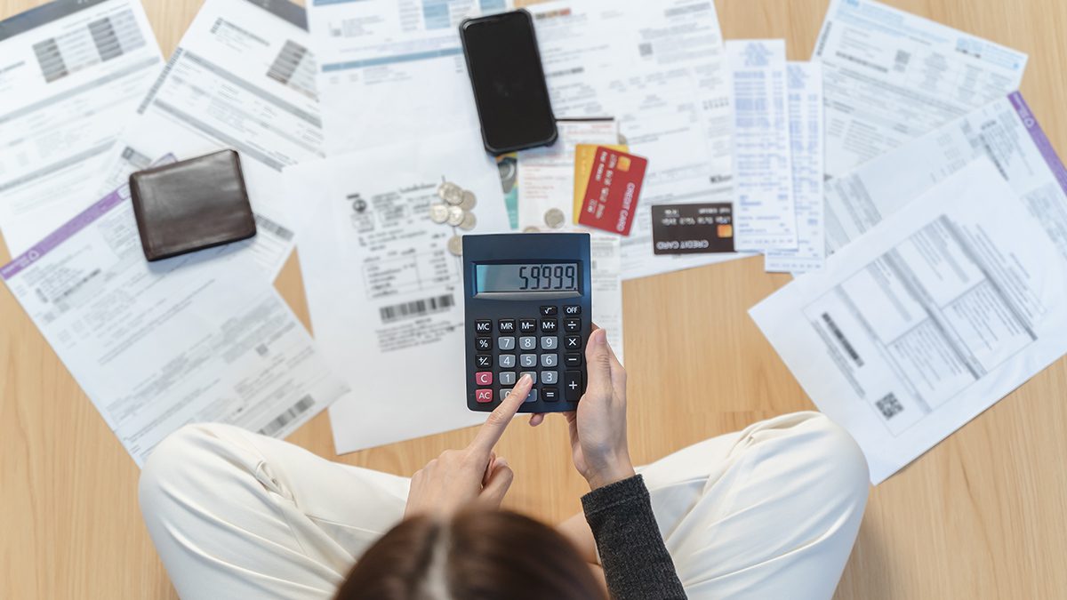 Woman looking at many credit cards in her hand and worried about loan debt pay late.
