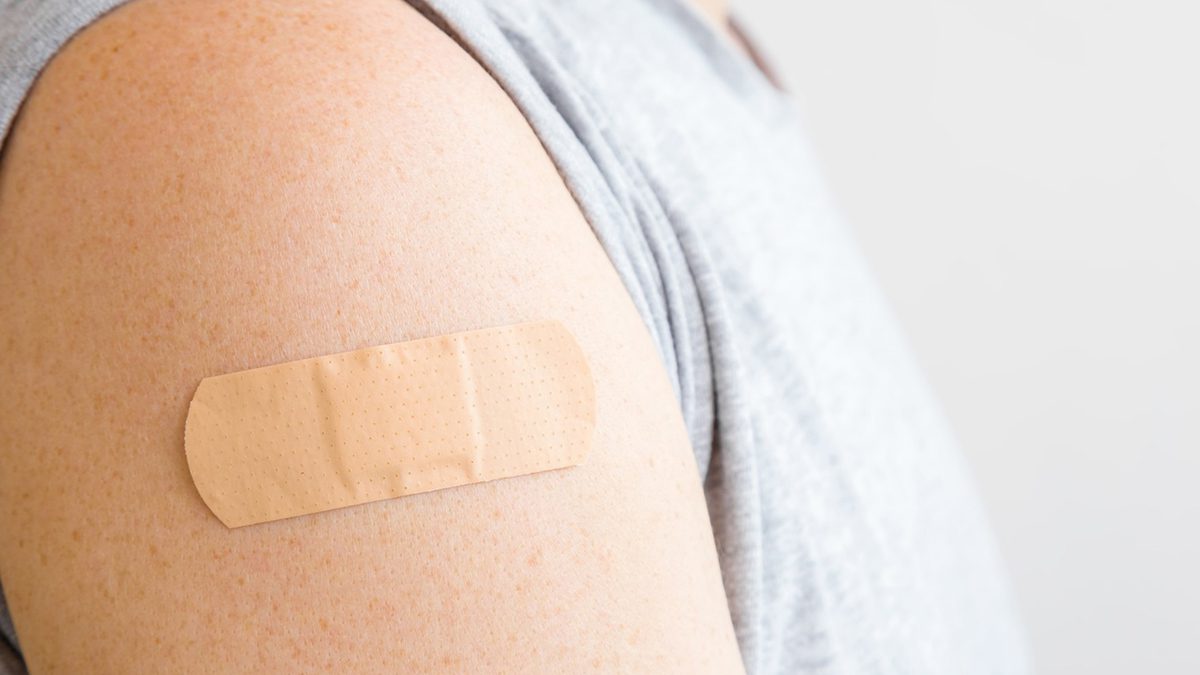 A bandage placed on someone's upper right arm.
