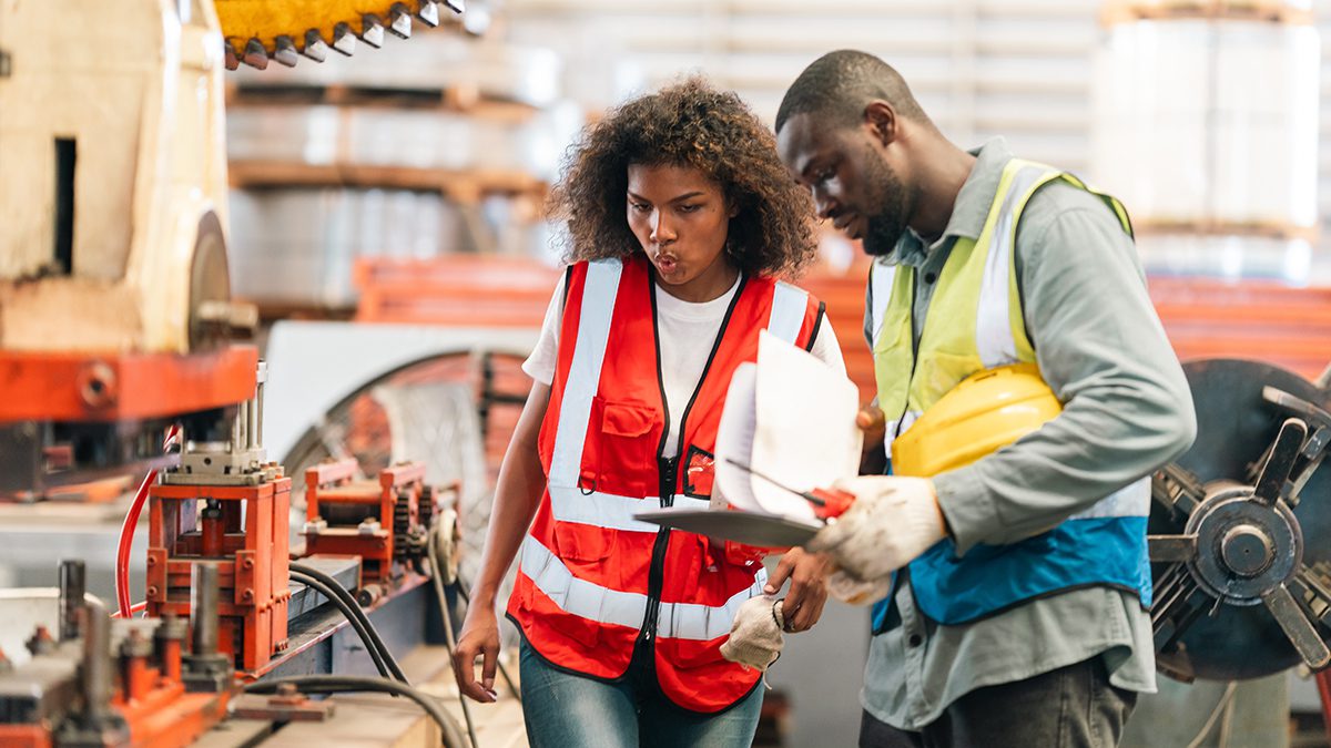 Engineers inspect industrial control systems ensuring safety efficiency and precision in a modern manufacturing environment with teamwork and technical expertise driving operational excellence