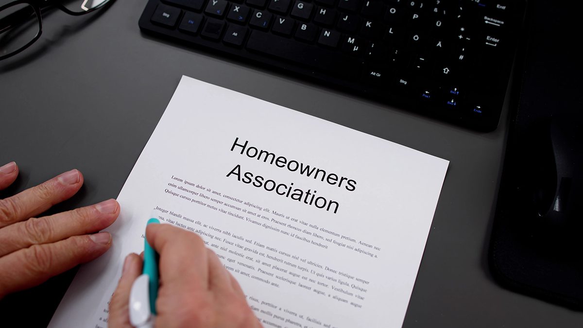 Person Reading HOA Rules And Regulations Document