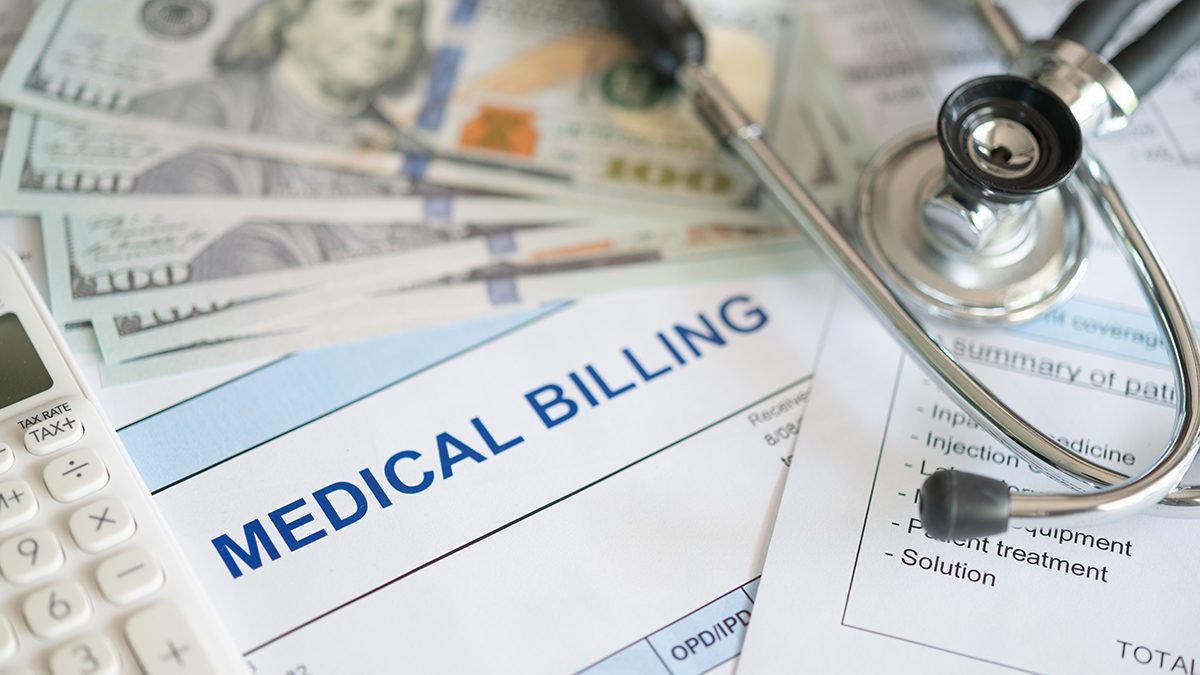medical billing document and dollar banknote, calculator, stathoscope. medical treatment expense concept.
