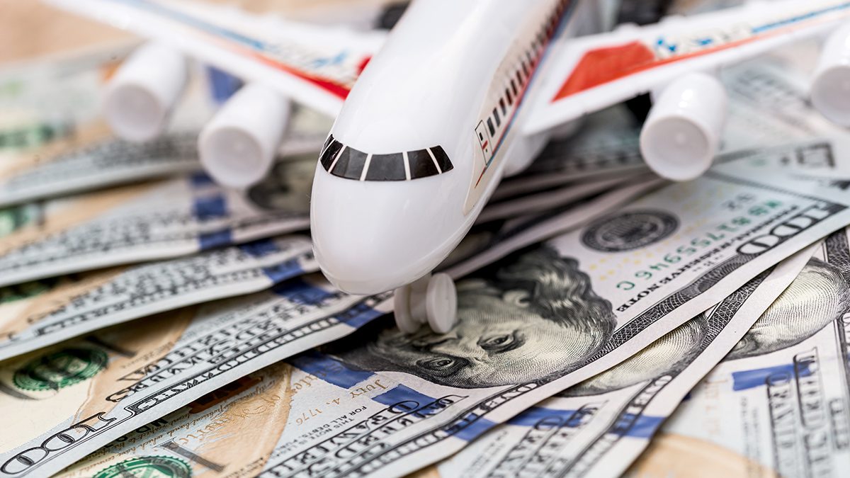 toy airplane on $100 dollar bills close up